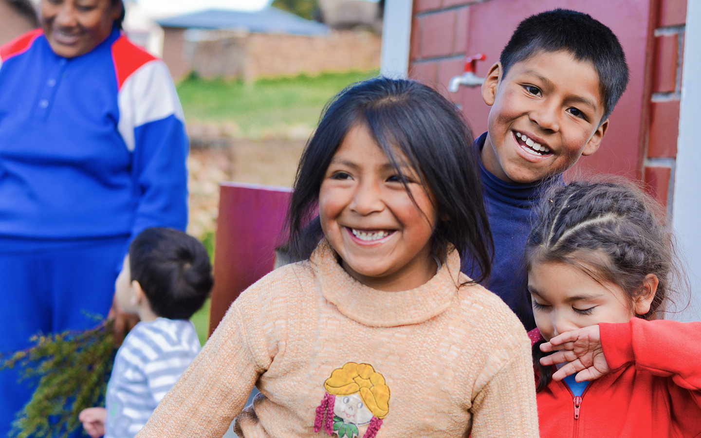 Community members gathered around shared tables in a neighborhood street